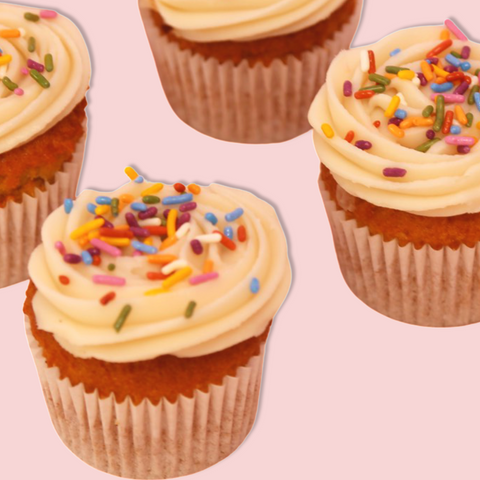 Close-up of beautiful vanilla cupcakes with multi-colored sprinkles.