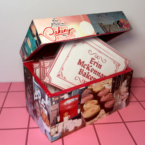 Collaged EMB recipe box with lace details on a pink tile floor 