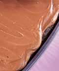 Close-up of a chocolate cake with a smooth layer of chocolate frosting.