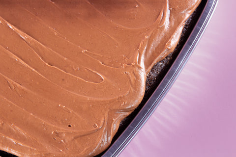 Close-up of a chocolate cake with a smooth layer of chocolate frosting.