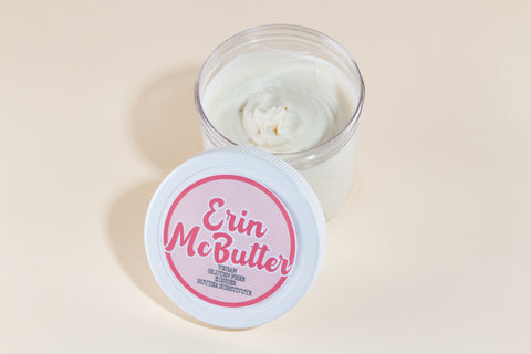 Open container showing creamy white Erin McButter vegan butter substitute with pink labeled lid beside it from Erin McKenna's Bakery