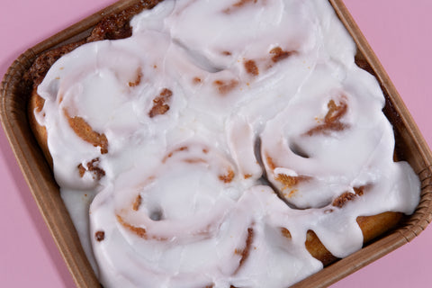 Dairy-free cinnamon rolls with generous vanilla glaze drizzle from Erin McKenna's Bakery, allergen-friendly