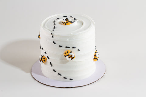 Individual 3-inch honey apple cake with vanilla frosting and cute bee toppers, ideal for High Holiday celebrations