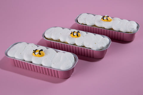 Honey apple mini cake flight in rose gold tins with white frosting and bee decorations, perfect for High Holiday celebrations