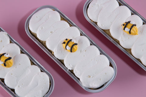 Three vegan gluten-free honey apple mini loaf cakes with vanilla frosting and fondant bee toppers, kosher certified