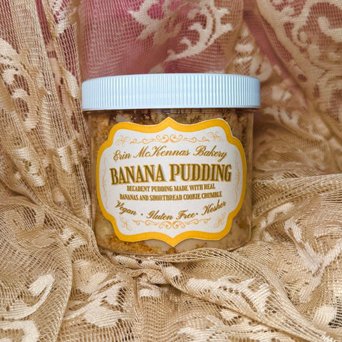 Erin McKenna's Bakery vegan gluten-free kosher banana pudding jar with shortbread cookie crumble layers and pale blue lid on gold lace fabric