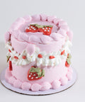Pink cake with strawberry decorations on a white background