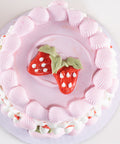 Pink cake with strawberry decorations on a white background